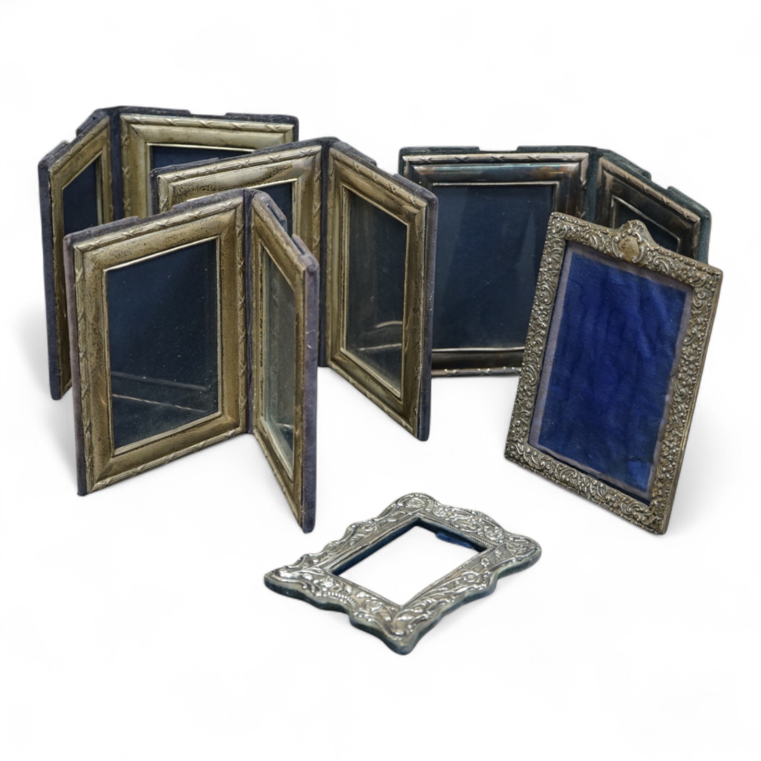 A late Victorian repousse silver mounted rectangular photograph frame, Birmingham, 1898, 17.9cm, a smaller Edwardian silver mounted photograph frame, Williams Ltd, Birmingham, 1905 and a set of four modern silver mounted